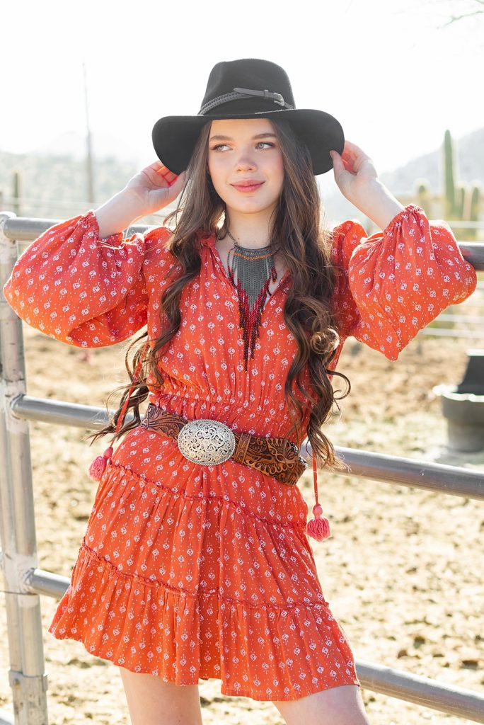 Cute Karina poses with her cowboy hat during a rustic Sonoran ranch styled session.