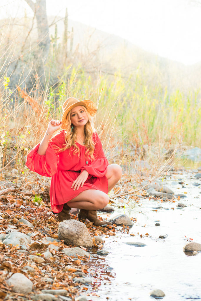 Beautiful Addisyn poses in the gorgeous golden hour light during a captivating Cave Creek senior portrait session.