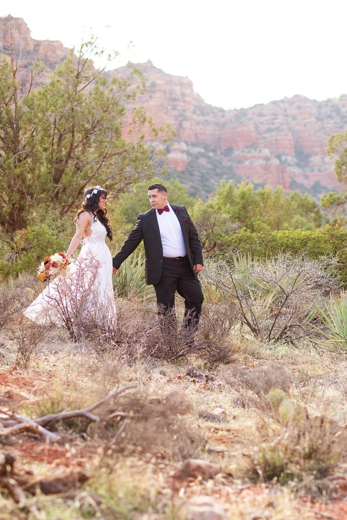 Anniversary bride and groom look lovingly into each other's eyes as they glide gracefully on a trail in Sedona, Arizona.