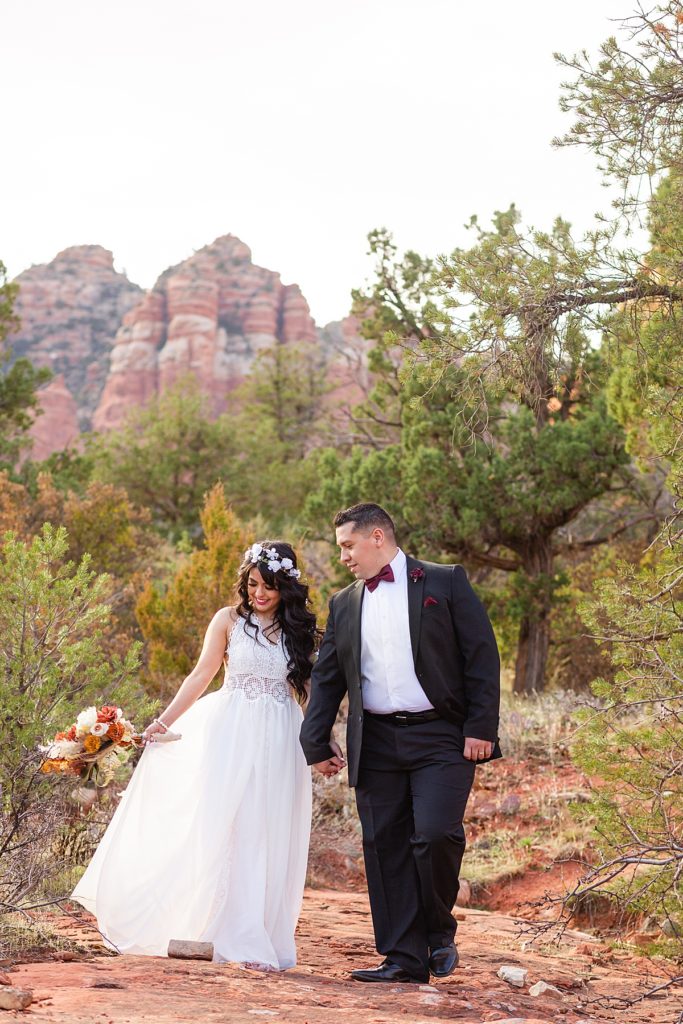 Woman admires beautiful bouquet during anniversary session in Springtime in Sedona, Arizona. 
