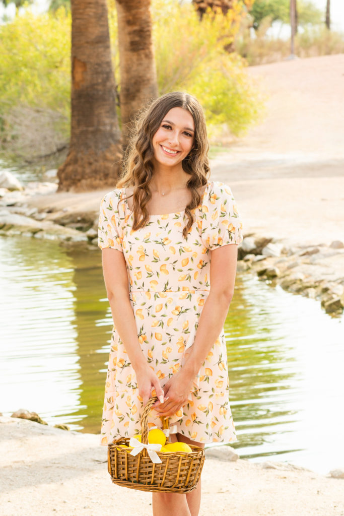 2022 senior grad Kylie smiles in the sunshine while posing at Papago Park