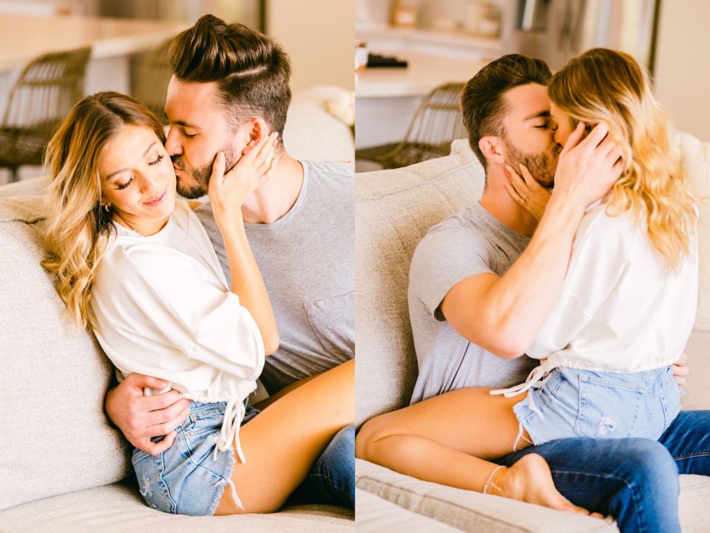 Newly engaged Kayci and Caleb cuddle on the couch during a lifestyle engagement session in Scottsdale, Arizona.
