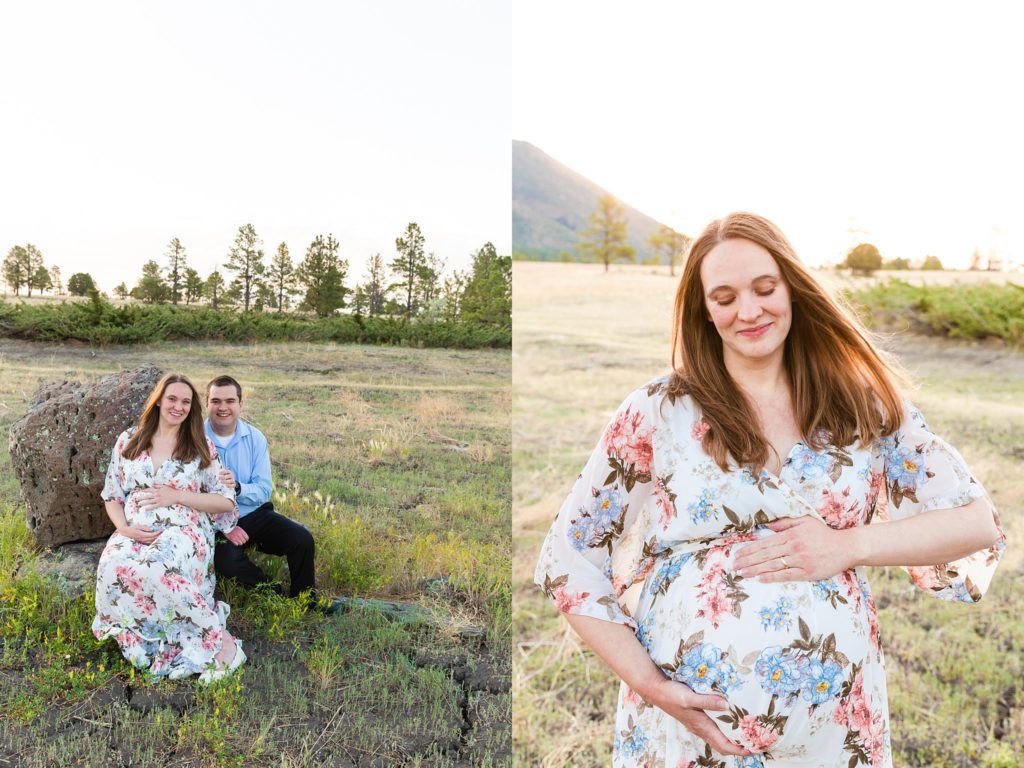 Soon-to-be mother and father sit on a rock in a gorgeous meadow during a maternity portrait session; expectant mother cradles her stomach and smiles during a maternity portrait session in Flagstaff, AZ.