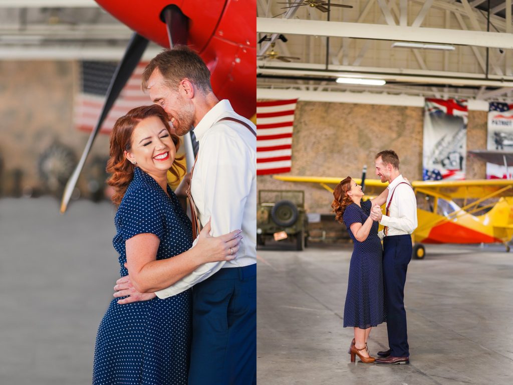 Surrounded by vintage planes of all styles, engaged couple dances during a portrait session with Bayley Jordan in Mesa, Arizona. 