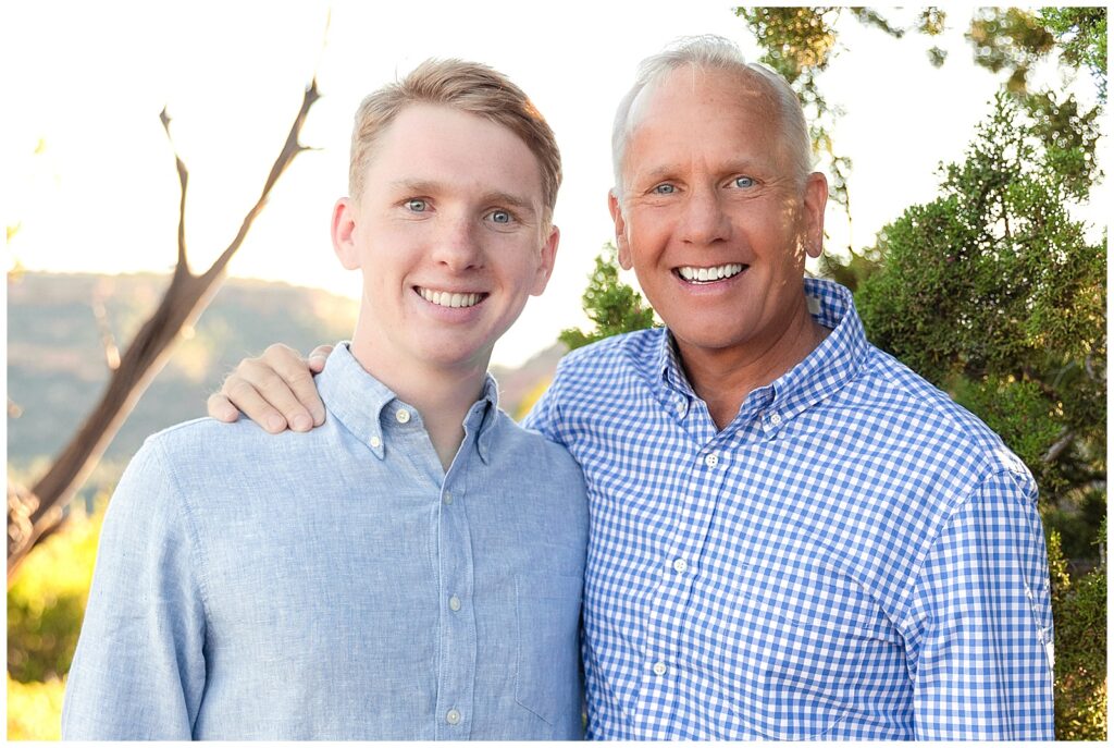 Father and son celebrate senior graduation in Sedona, Arizona during family portrait session with Bayley Jordan Photography.