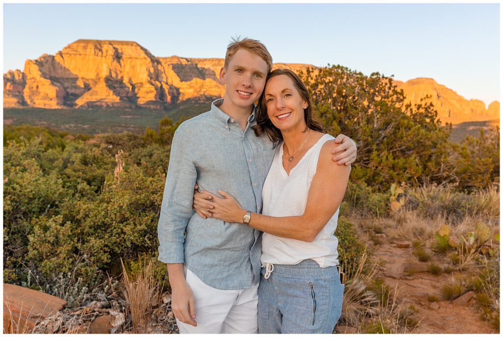 Mother and son share a close hug during a family portrait session in Sedona, Arizona at sunset. 