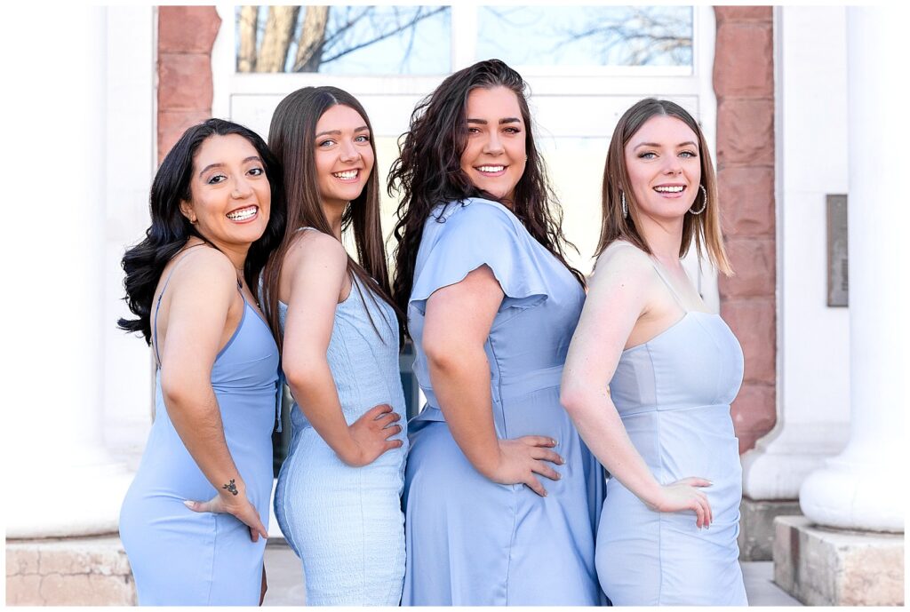 Four women pose in gorgeous light blue gowns to celebrate their graduation at Northern Arizona University 