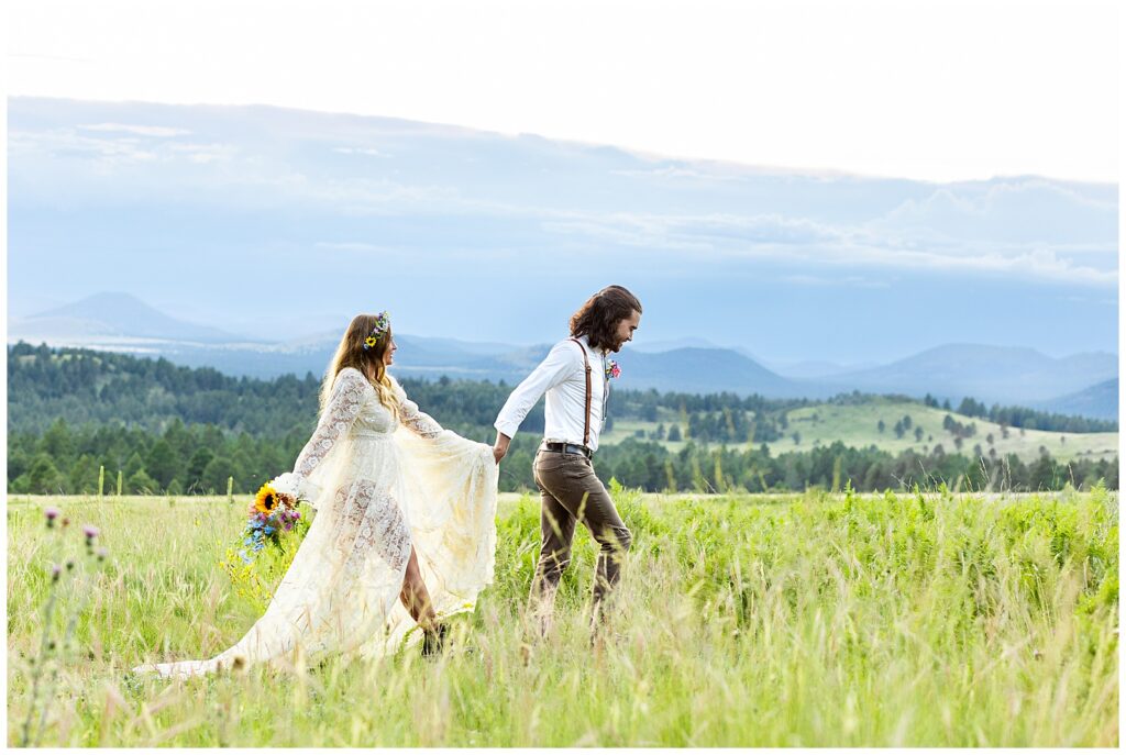 Eric leads Brooke through a field of flowers on the mountain top during their 10 year anniversary celebration in Flagstaff, Arizona. 