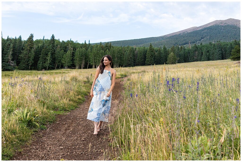 Holly smiles as she explores the various trails at the San Francisco Peaks in Flagstaff Arizona during NAU graduation portraits with Bayley Jordan Photography