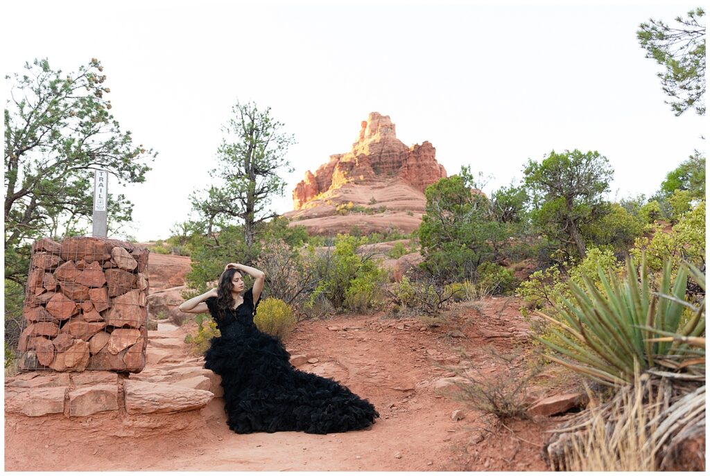 Editorial model, Holly, stuns in a long, black gown as she poses amidst the sunrise Sedona, Arizona red rocks
