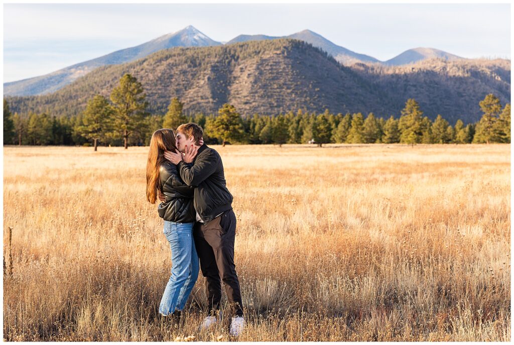 Couple Jay and Ashley share a kiss after getting engaged at Buffalo Park in Flagstaff, Arizona.