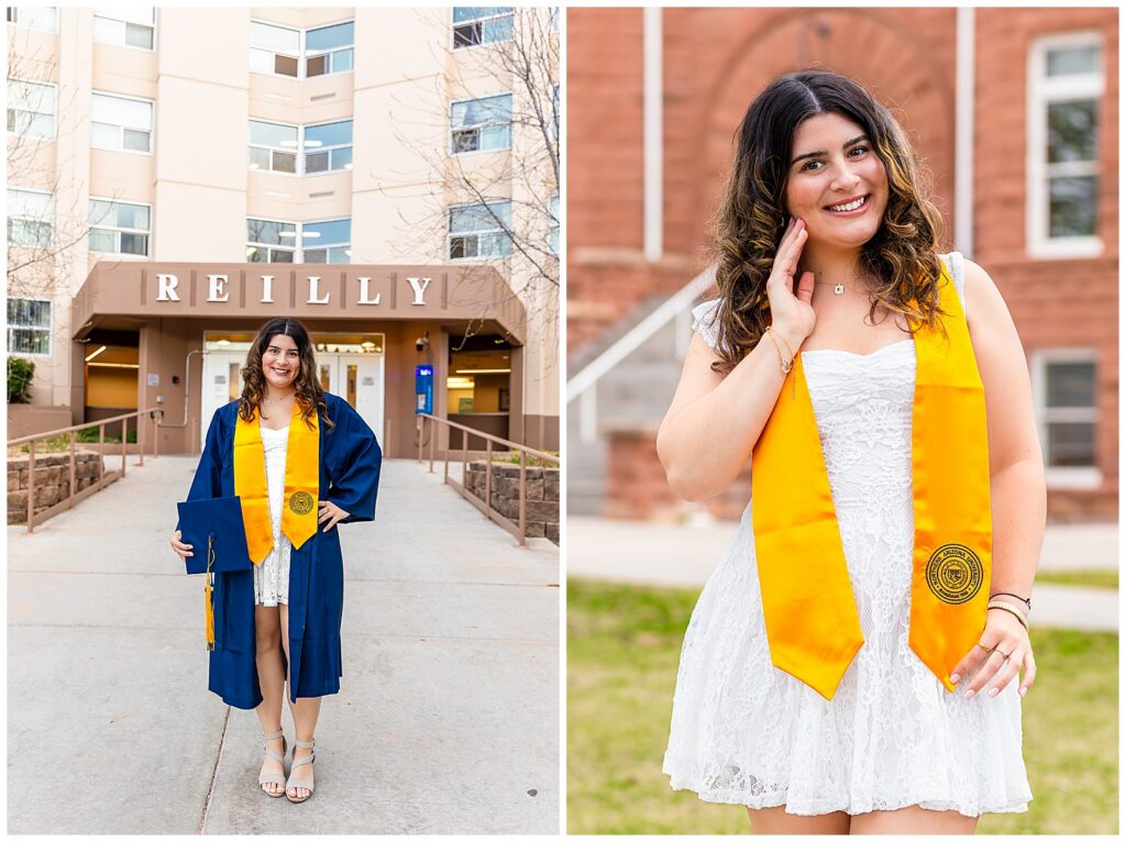 Northern Arizona University graduate posing in front of campus buildings Reilly residence hall and Old Main in blue and gold graduation attire