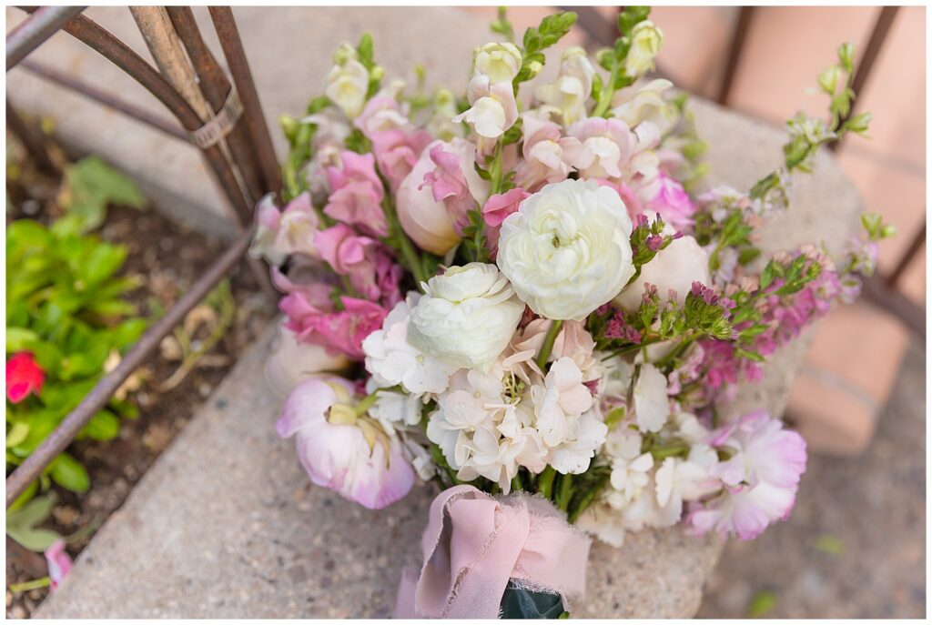 Colorful pink, purple, and white bouquet in Sedona, Arizona held by beautiful woman celebrating her anniversary in Sedona, Arizona at sunset.