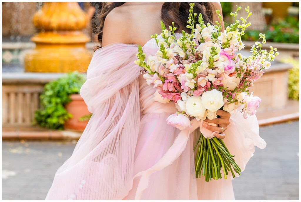 Colorful pink and white bouquet in Sedona, Arizona held by beautiful woman celebrating her anniversary in Sedona, Arizona at sunset.
